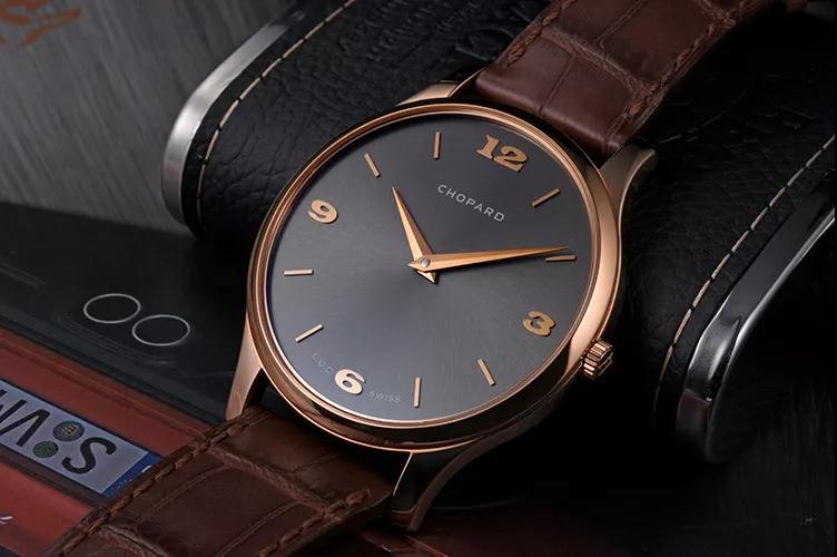 The rose gold hands and hour markers are in contrast to the dark gray dial.